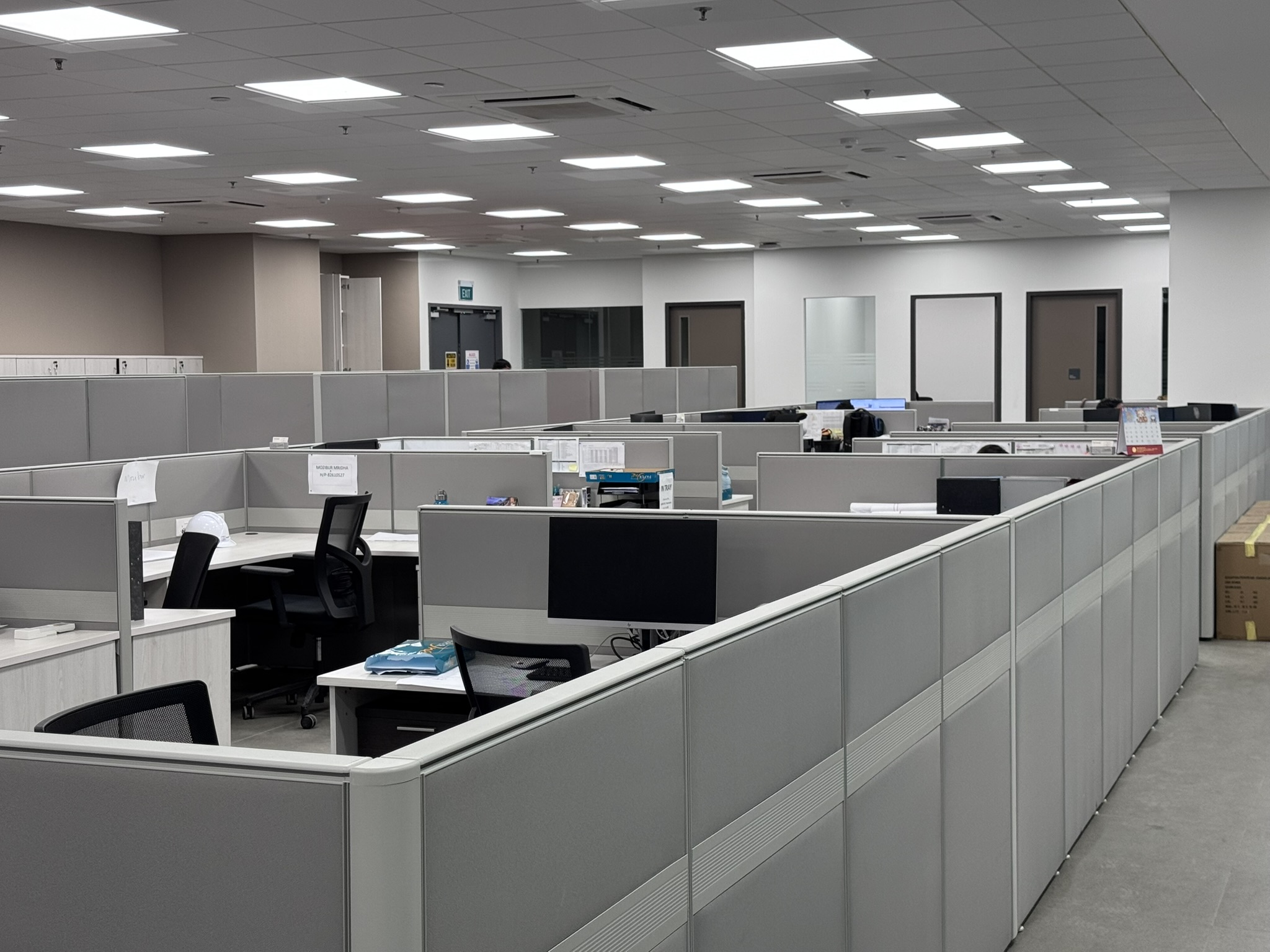 Open-plan office laid out with high-partition workstations in a Singapore workplace