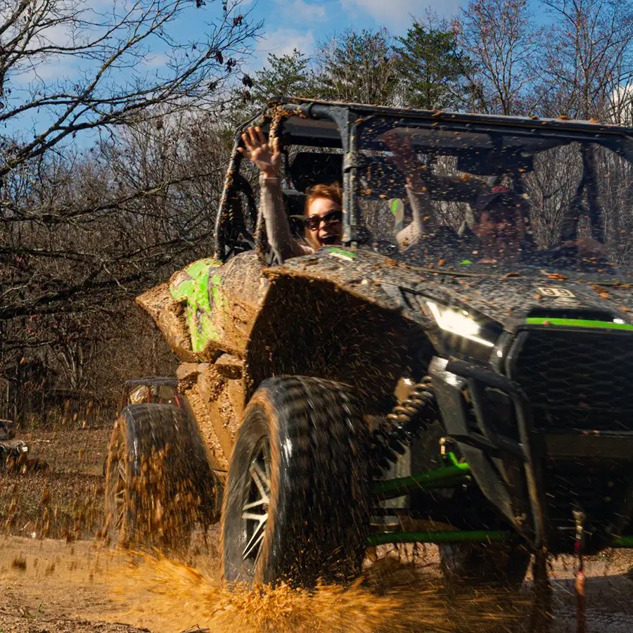 A happy girl enjoying off-roading in Gatlinburg in the mud