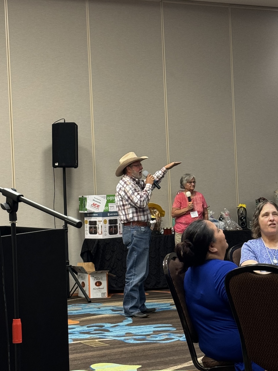 Jamie Crider auctioneering with Frances Poindexter assisting with the auction.