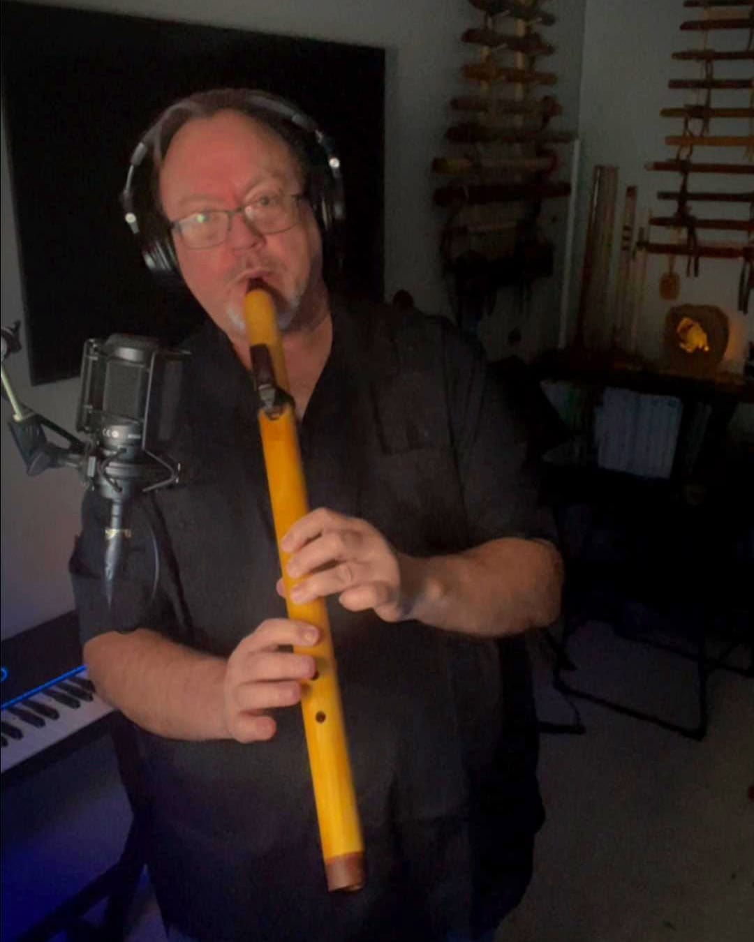 Bryan in his studio, laying down a flute track