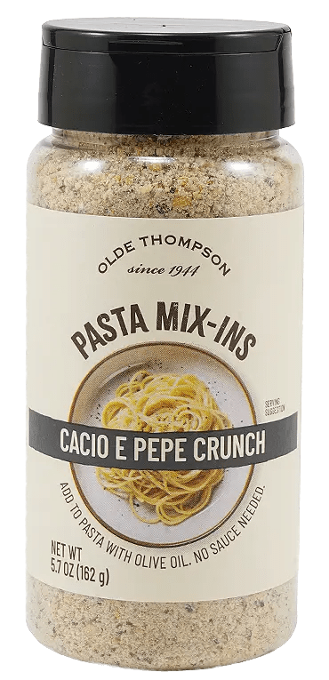 A bottle of Olde Thompson Pasta Mix-Ins labeled Cacio e Pepe Crunch with an image of spaghetti on the front. The label notes it is a seasoning to add to pasta with olive oil, with a net weight of 5.7 oz (162 g).