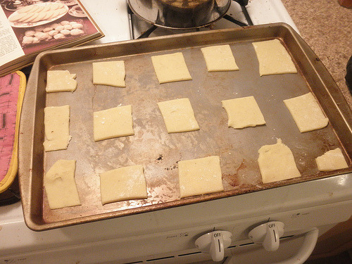 Butter cookie dough squares arranged on parchment paper on baking sheet ready for baking Sotterley Jumbles