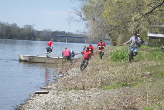 Group in red shirts launching boats for Shadfest river activity in Lambertville