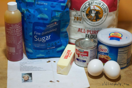 Vanilla Butternut Pound Cake ingredients including sugar, flour, eggs, butter, and evaporated milk on kitchen counter