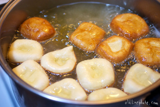 kinkling doughnuts frying in oil, traditional Lenten pastry recipe preparation