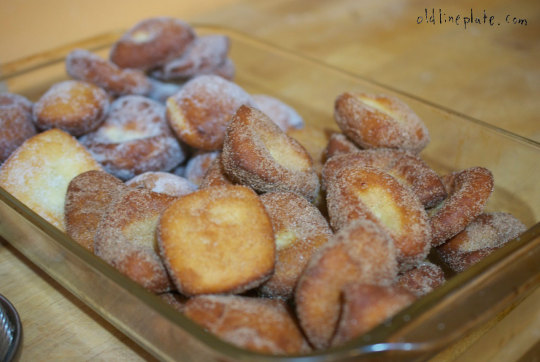 Homemade cinnamon sugar coated kinkling pastries, golden brown fastnachts küchlie on a glass plate