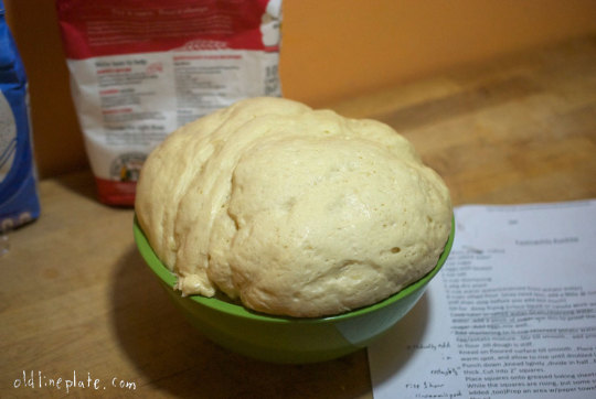 Homemade dough for Fastnachts Küchlie fried pastries rising in green bowl during traditional Lenten recipe preparation