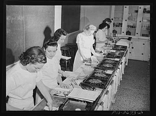 Women operating kitchen equipment at test kitchen, circa 1940s-1950s