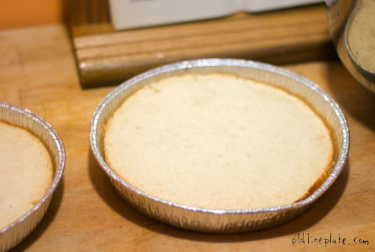 Silver Cake in aluminum pie tin on wooden surface