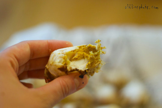 Hand holding a crab body half with visible crab meat