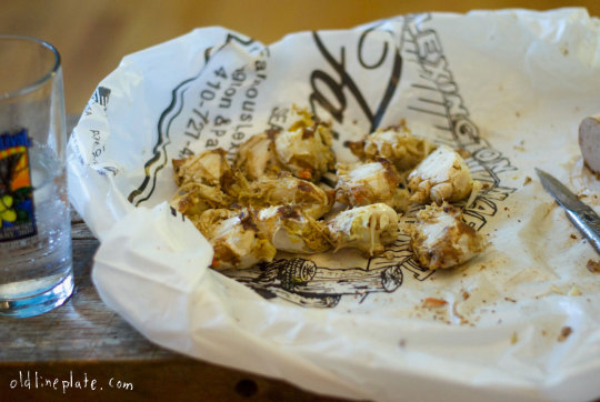 crab halves on Faidleys bag with decorative text and water glass