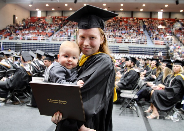 Lorelei Kelly of Rochester holds her five-month-old son Riggins and her Bachelor of Science degree from the School of Education at St. Bonaventure University's 164th Commencement at Reilly Center on Sunday, which was Mother's Day. (Photos by Rick Miller)