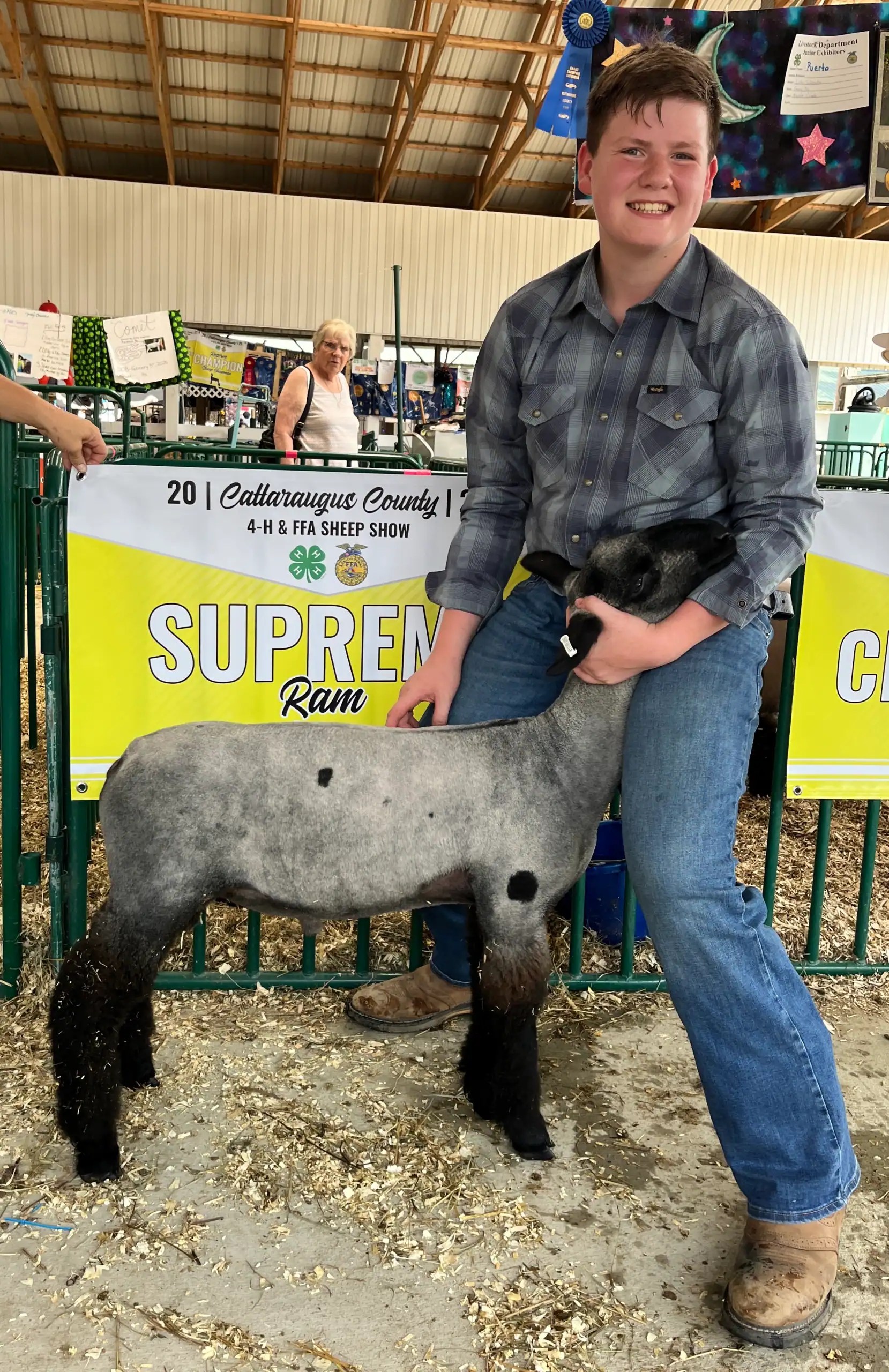 (Rick Miller/Olean Star) Ethan Boutelle of Kennedy displays his Supreme Lamb Wednesday at the Cattaraugus County Fair. The lamb will be in the Market Animal Auction on Saturday morning.