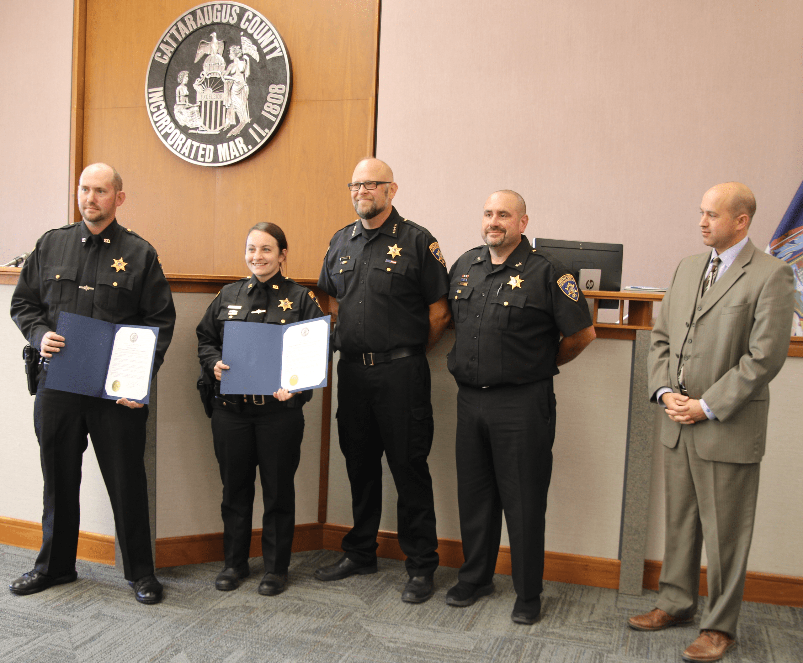 (Rick Miller/Olean Star) Cattaraugus County Sheriff’s Deputies (from left) Andrew Schumaker and Rachel Zimmer were presented commendations from County Legislature Chairman Andrew Burr (right) for their life-saving efforts involving a West Valley man in shock from numerous bee stings on July 26. Others are Sheriff Eric Butler (third from left) and Undersheriff Nate Root.