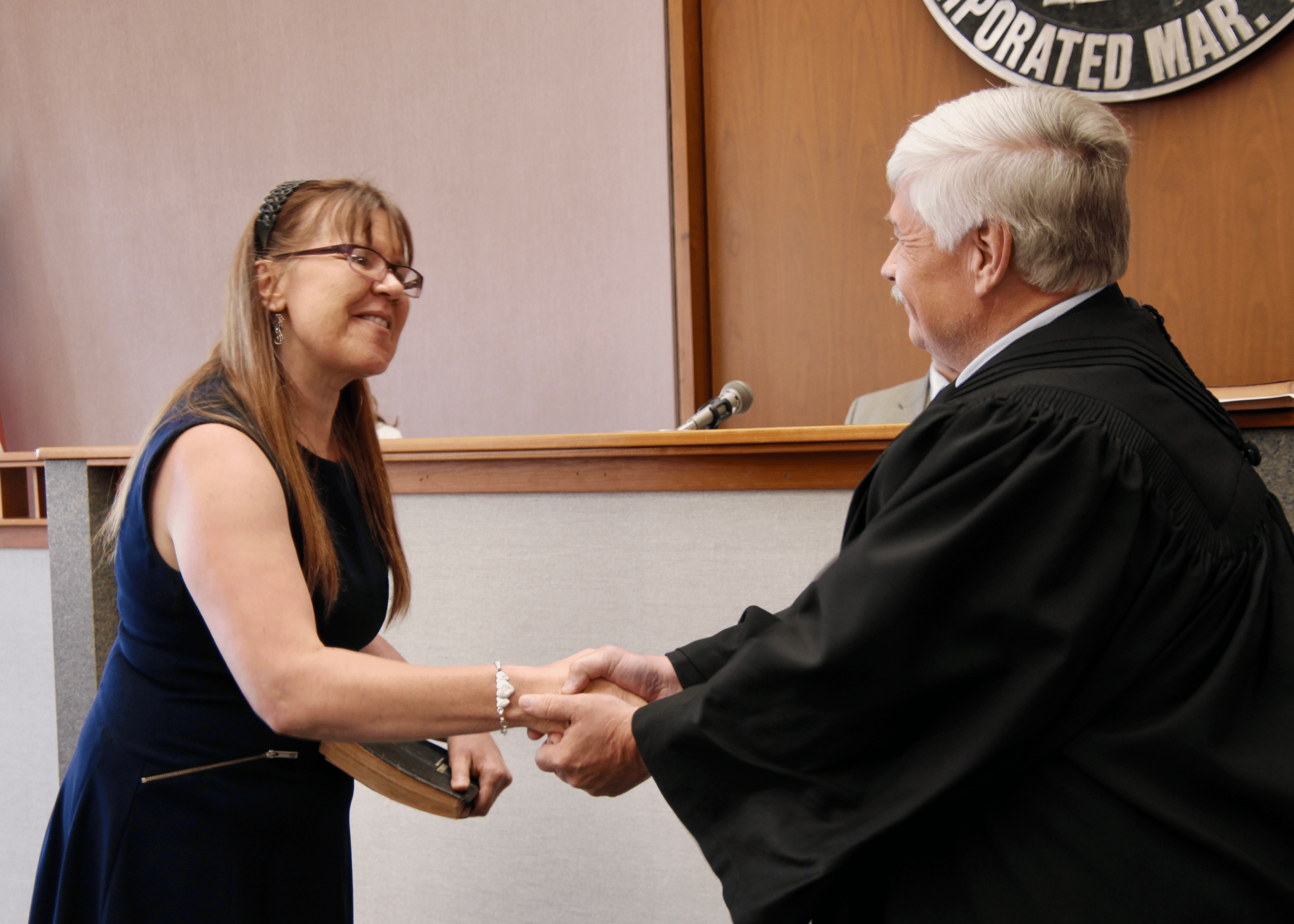 (Rick Miller/Olean Star) New Cattaraugus County Legislator Brenda Hansen of Delevan is congratulated by Cattaraugus County Court Judge Ronald Ploetz after she was sworn in Wednesday.