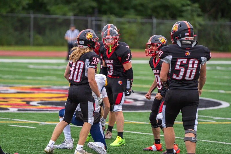 Logan Kohler celebrates with his teammates after connecting on a big hit during the Owls' Week Two meeting with the Terrors. | Photo by Hunter O. Lyle
