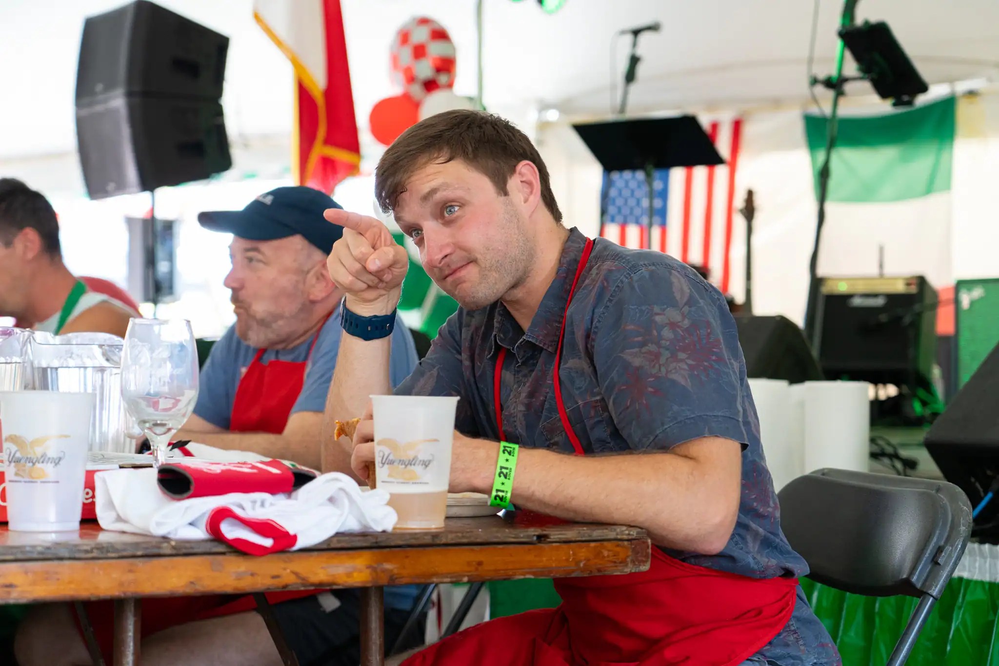 Holding his eighth slice in hand, Alex Colosmo points to his fans in the crowd moments before winning the Italian Fest's first-ever pizza eating contest. | Photo by Hunter O. Lyle