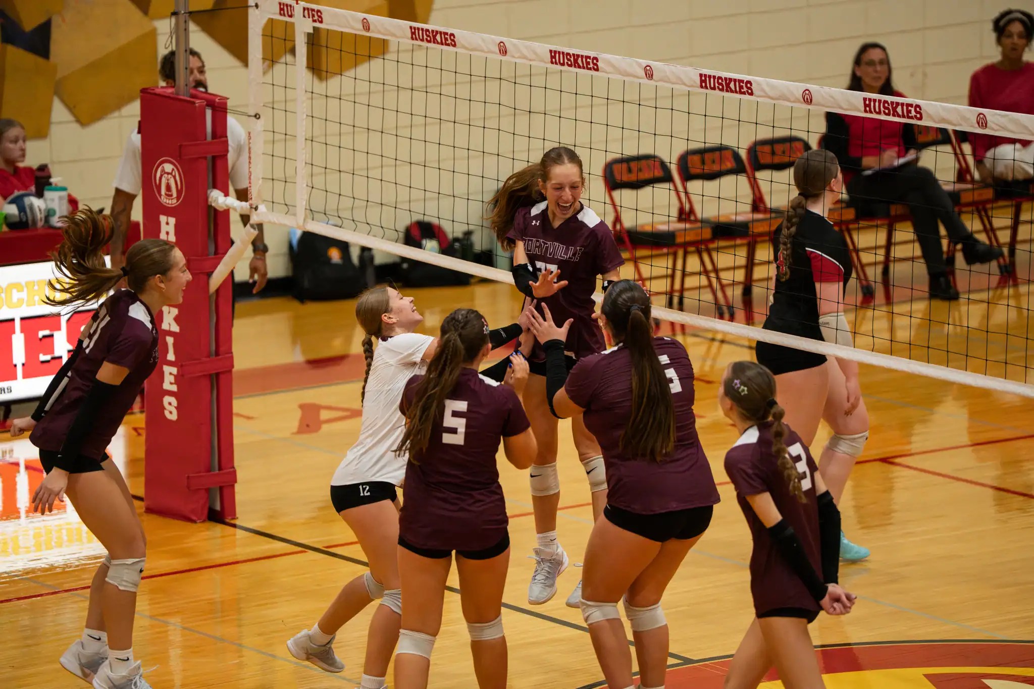 The Portville volleyball team celebrates during their win over Olean. | Photo by Hunter O. Lyle
