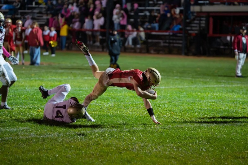 Dom Myers breaks through contact, crashing into the endzone to put the Huskies in front of the Chargers. Myers ended with four touchdowns in the win. | Photo by Hunter O. Lyle