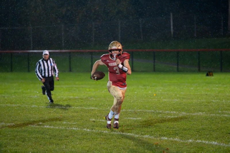 Dom Myers scrambles out of the pocket during Olean's blowout win over the Chargers. | Photo by Hunter O. Lyle