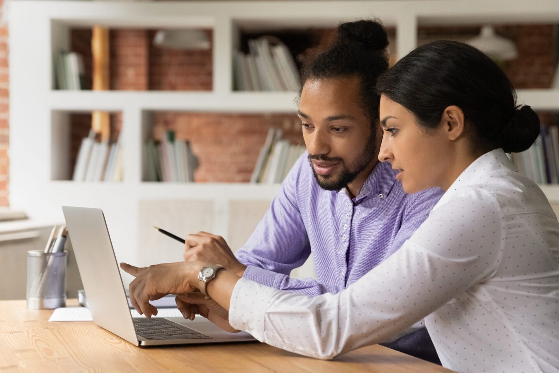 Nonprofit database manager and director of development collaborating on fundraising goals