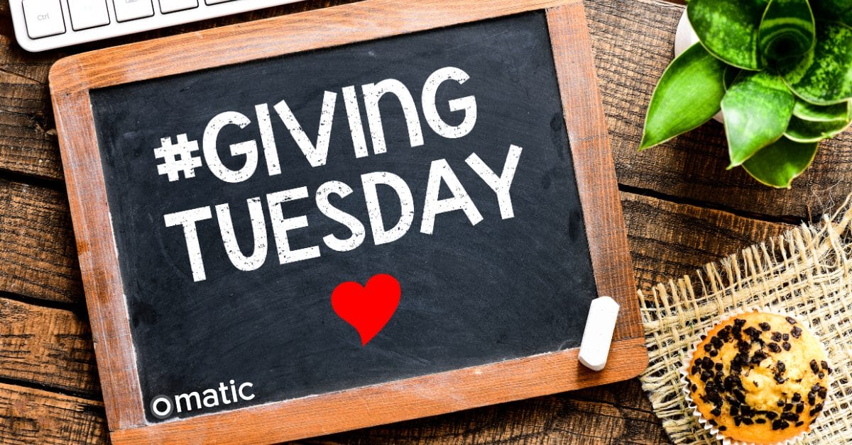 a chalkboard with a heart and a keyboard displaying giving tuesday from Omatic Software