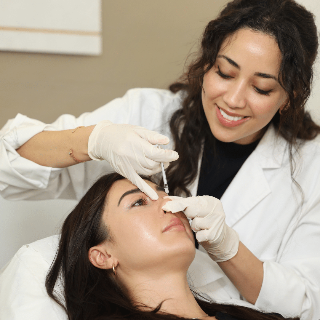 Doctor performing non surgical nose filler treatment