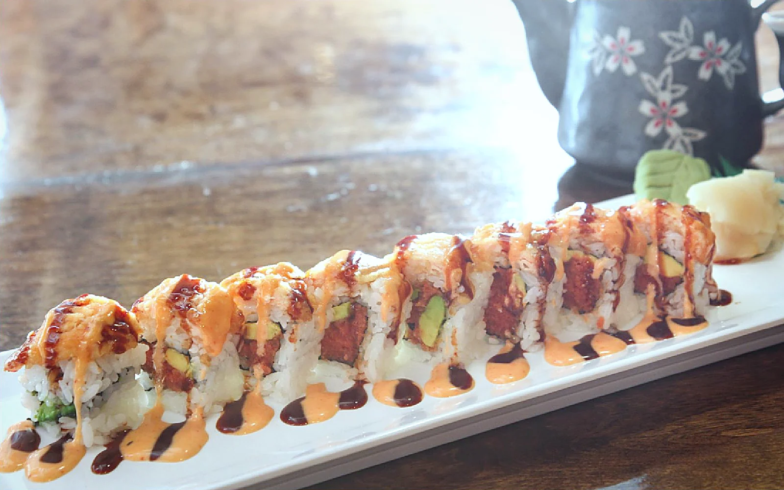 Sunset Roll topped with salmon tempura and spicy mayo
