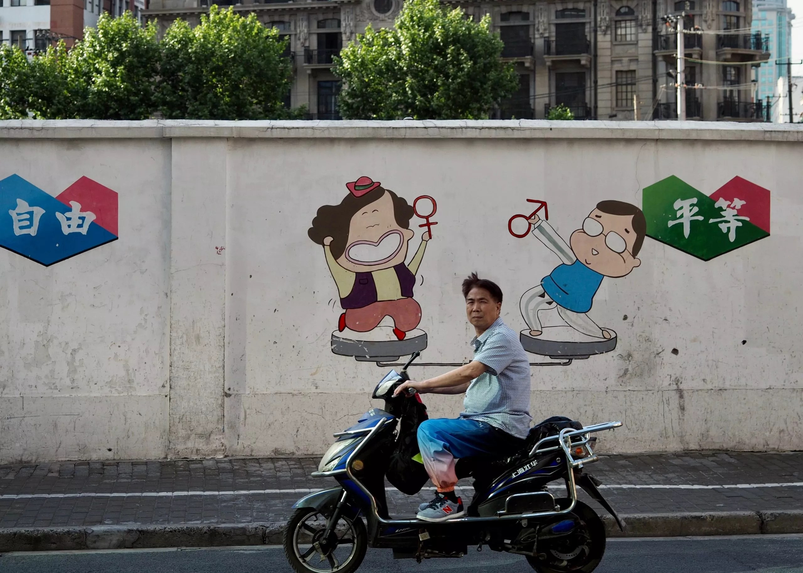 Man on a scooter in Shanghai, China.