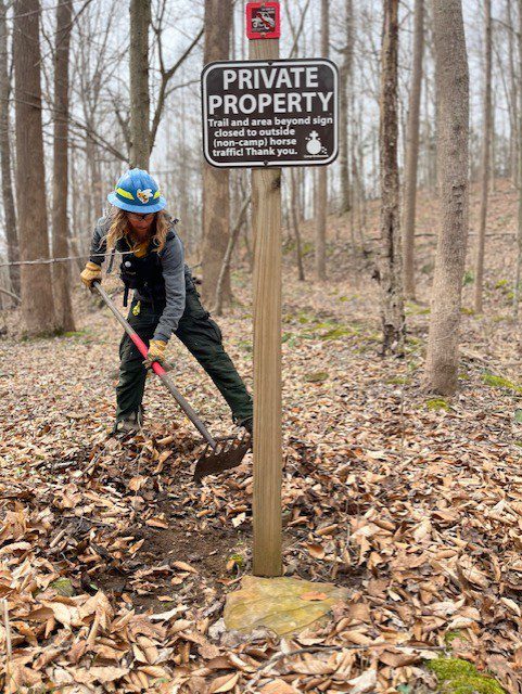Person digging trail near private property sign