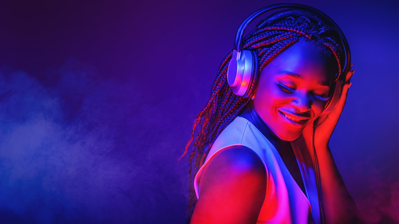 woman of color listening to headphones