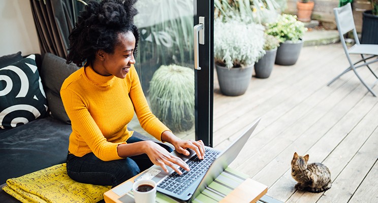 woman working on a computer in her living room