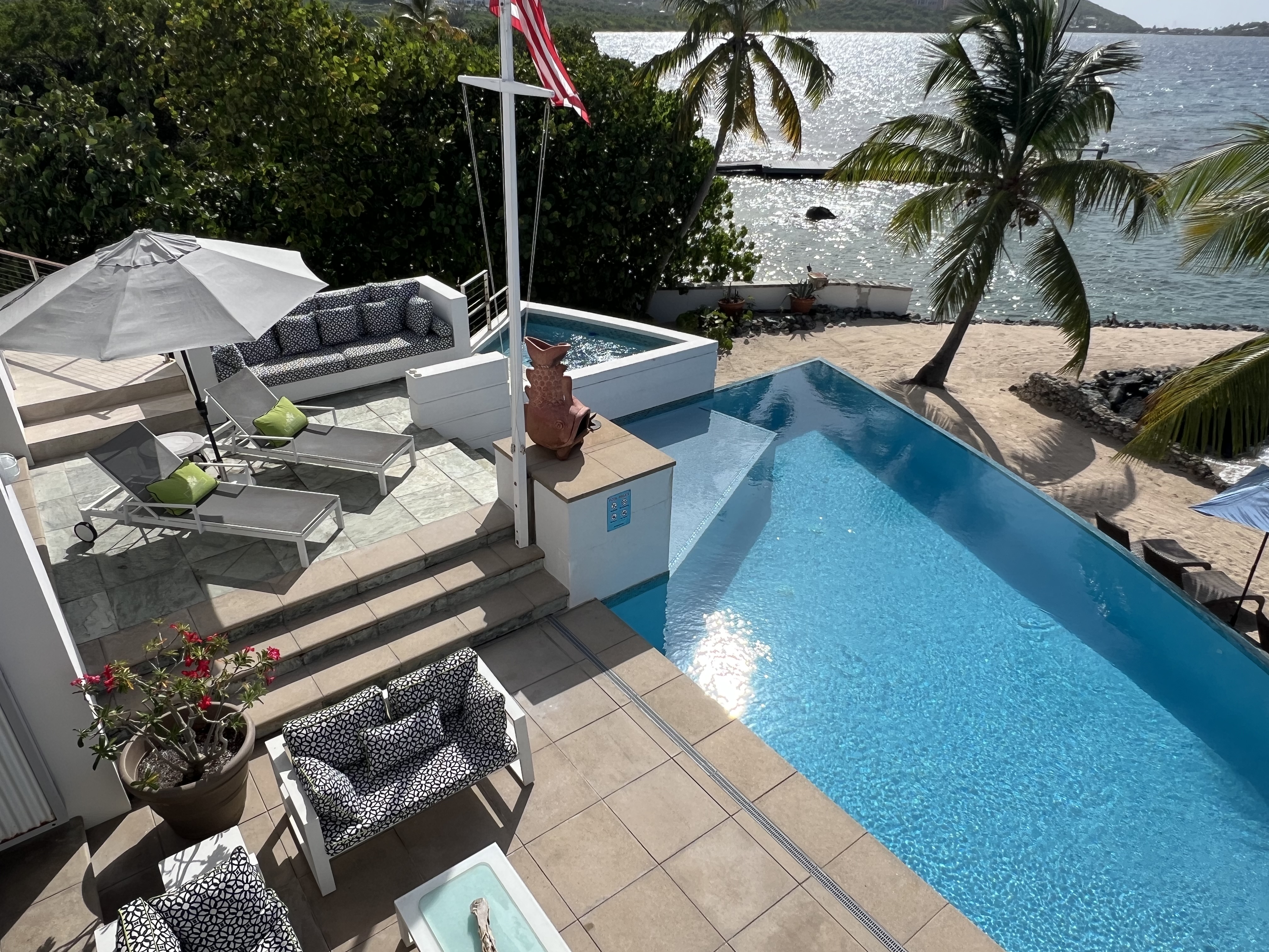 Spacious lush pool deck to lay out or do yoga