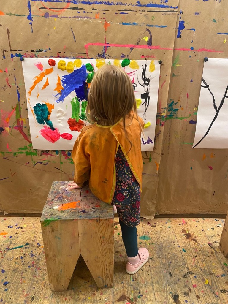 Child painting at Kids Club, Feuerstein Nature Family Resort