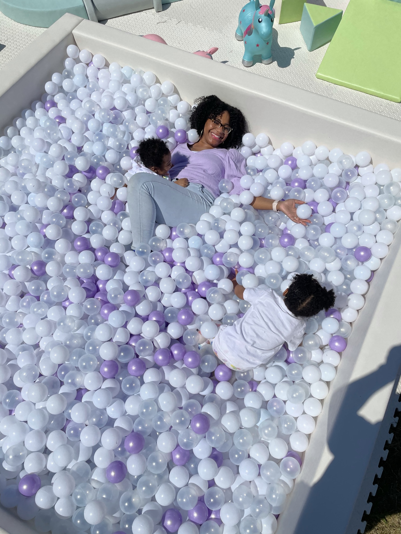 Me and my two daughters playing inside the ball pit in an overhead shot