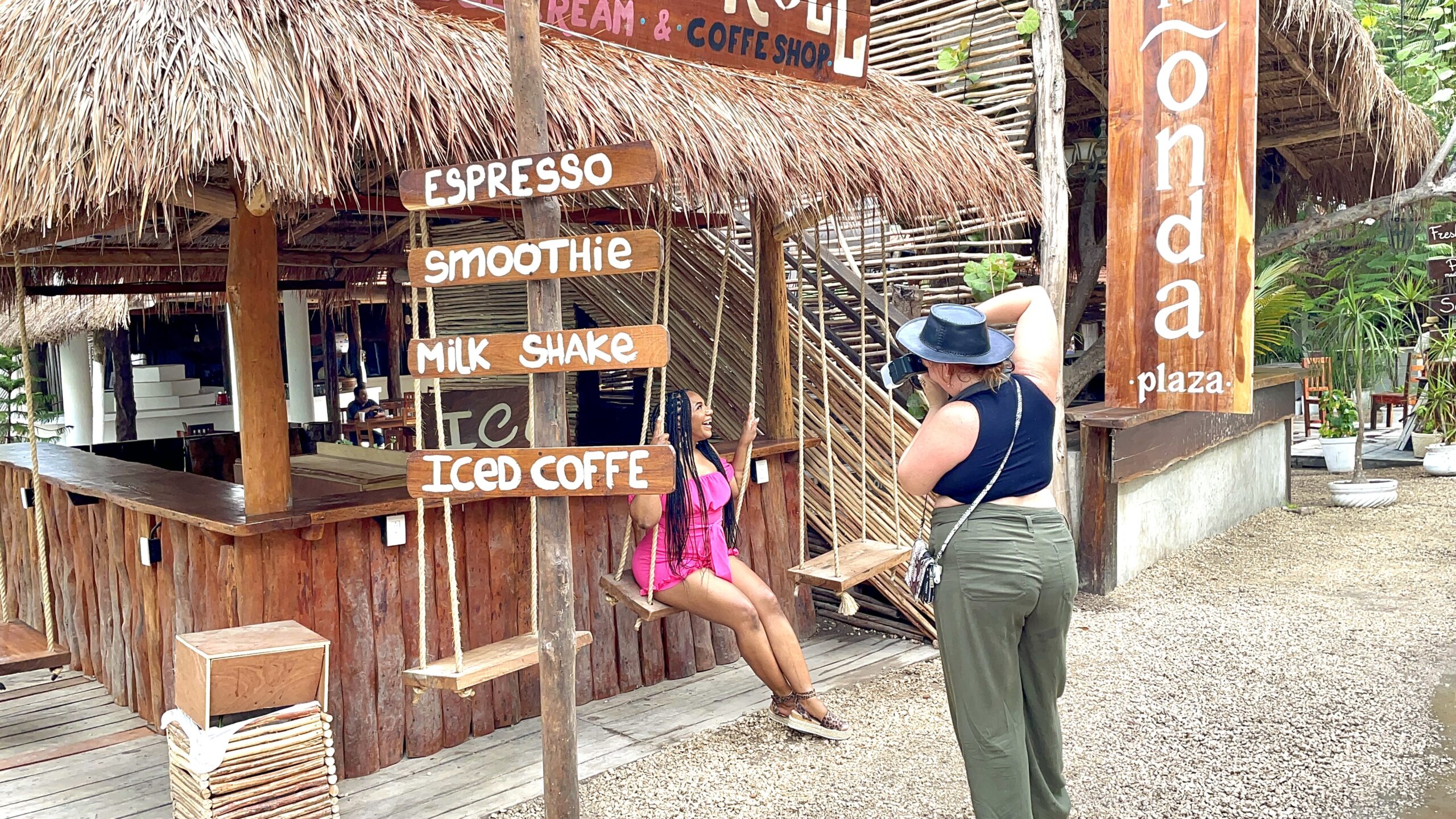 tulum photographer taking vacation pictures of one fly mama in pink romper on a swing