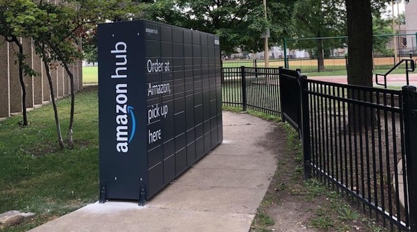 A very large Amazon locker, blocking much of a sidewalk.