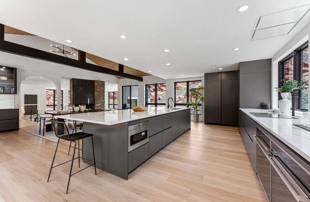 Modern Luxury Residential Kitchen with custom cabinetry quartz countertops and a large central island designed by One Room Atelier in Denver