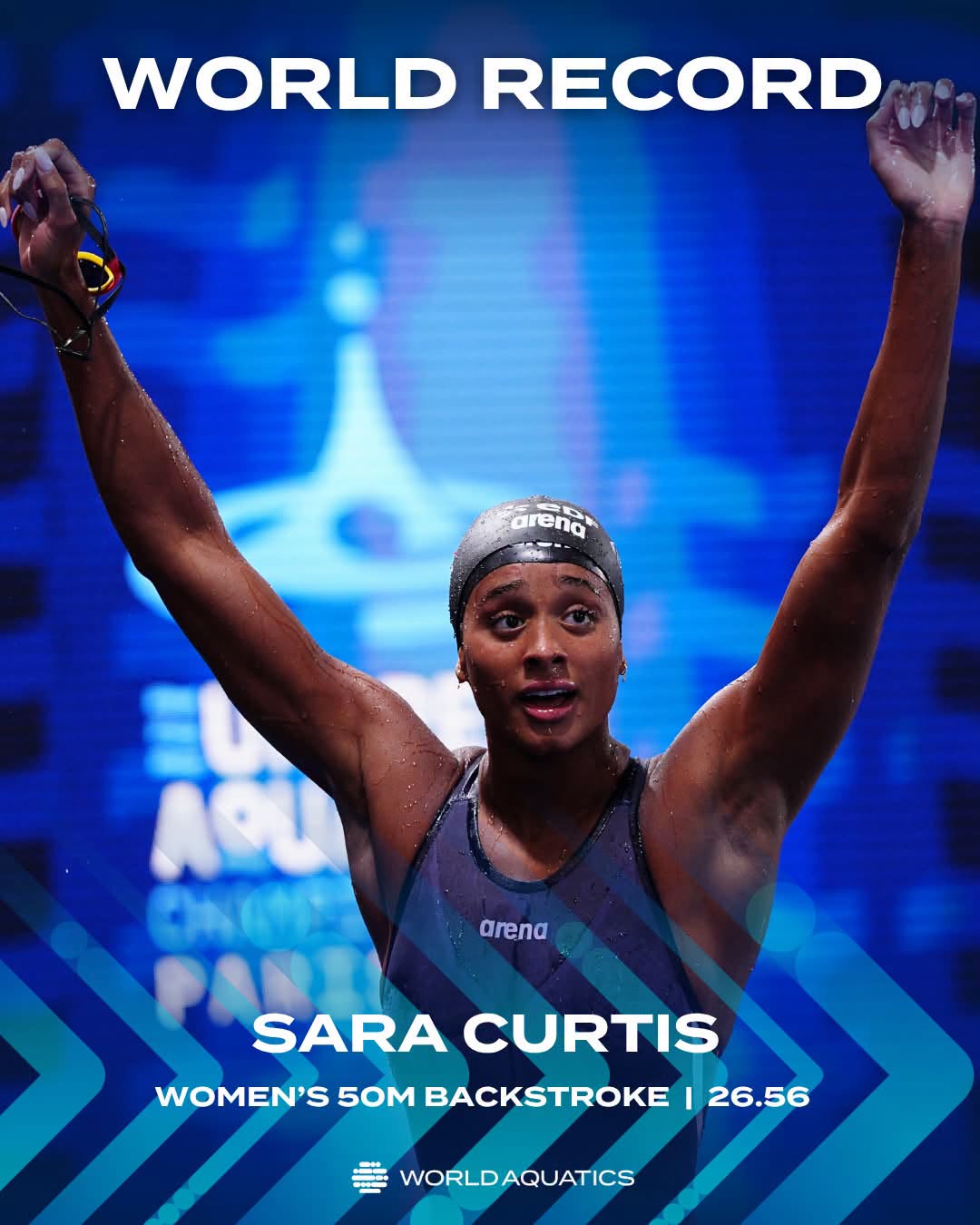 Italian swimmer Sara Curtis raises her hand in victory in the pool after setting the 50m backstroke world record.: Photo from World Aquatics wall