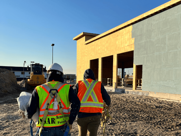 Onsar Group workers on a stucco project