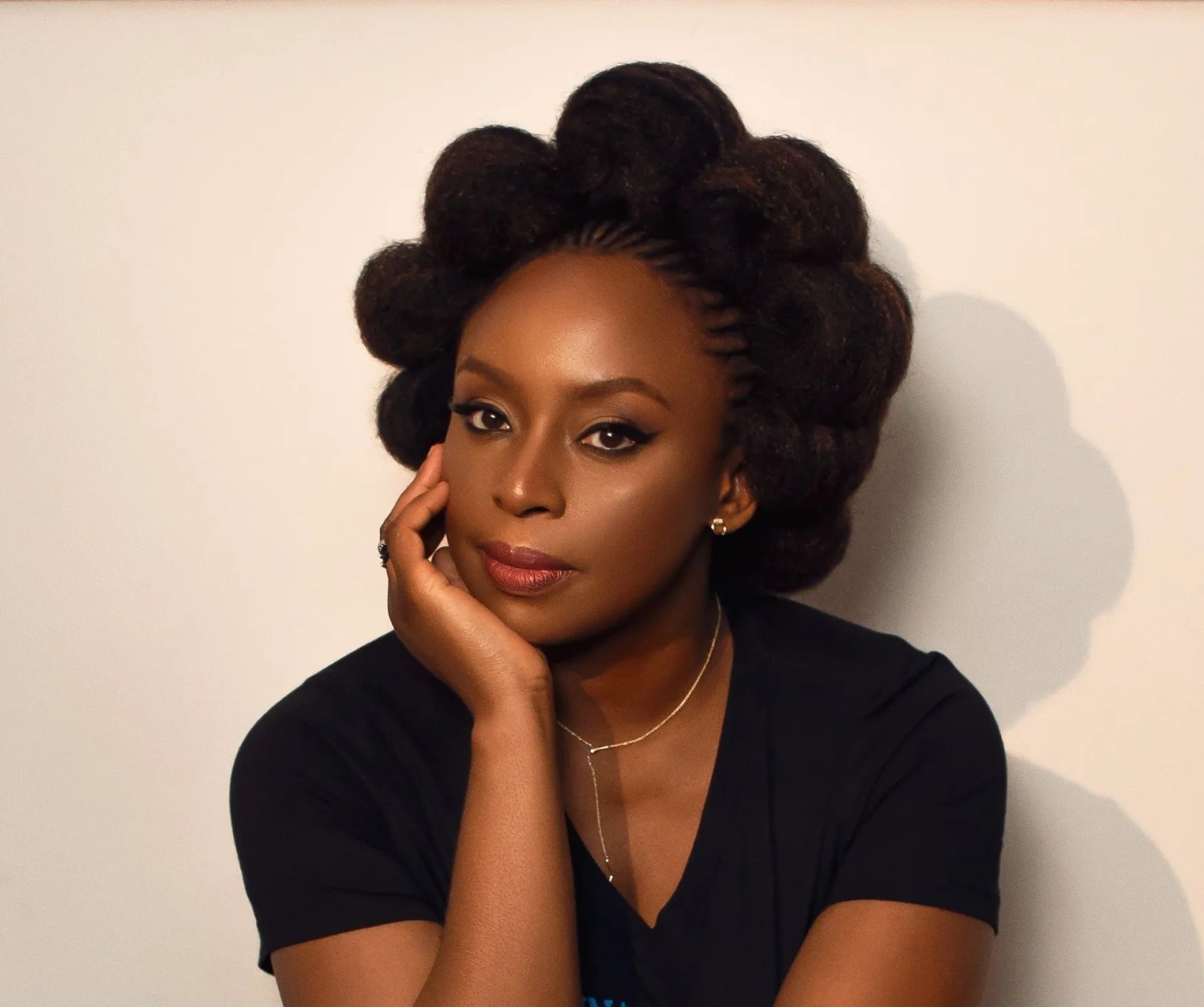 Feminism and Postcolonialism: Intersectional Themes in English Literature 6 Portrait of Chimamanda Ngozi Adichie, a leading feminist and postcolonial author, showcasing her distinctive hairstyle