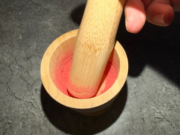 Grinding down strawberries.