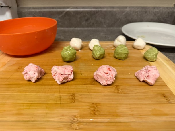 Tearing up the dough balls into four pieces each.