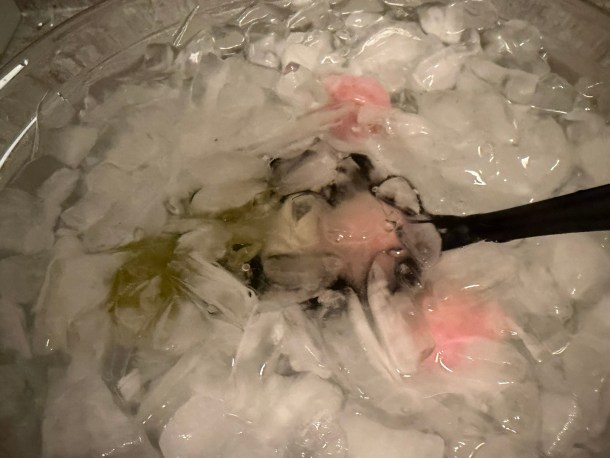 Dunking the dough balls into the ice water.