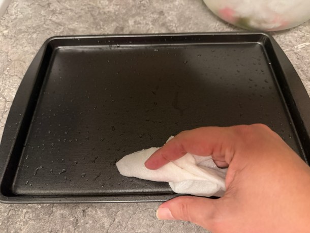 Wetting a baking sheet.