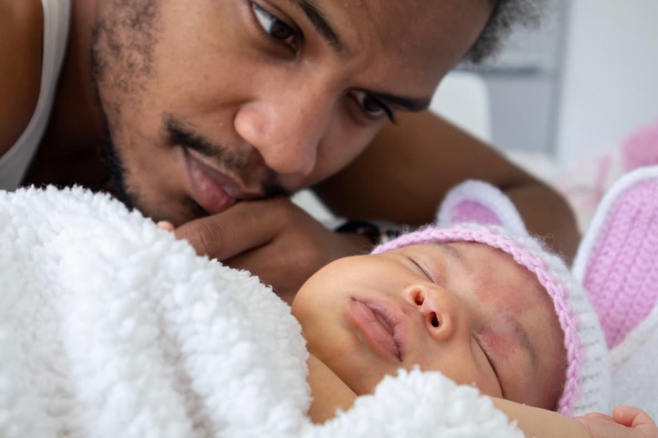 Person looking at a sleeping baby