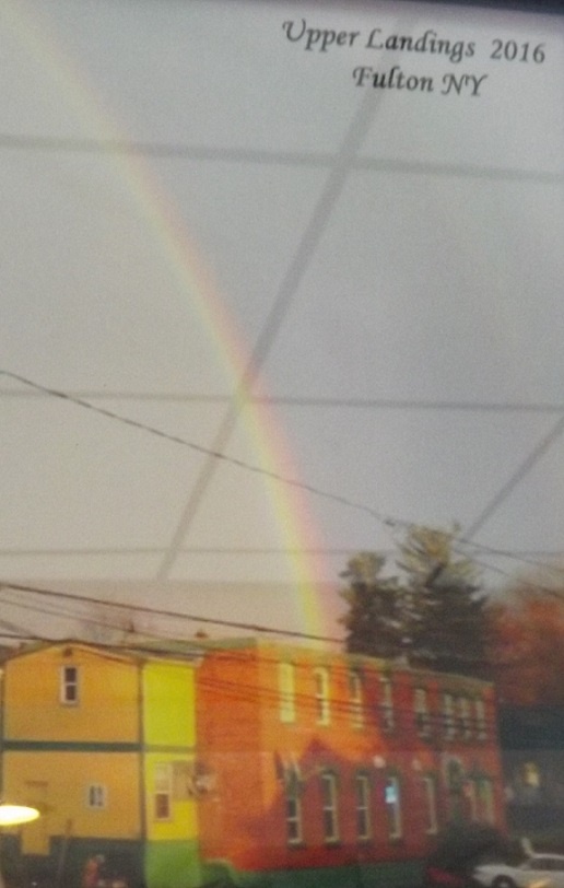 A picture displayed in the restaurant showing Upperlandings as the end of the rainbow.