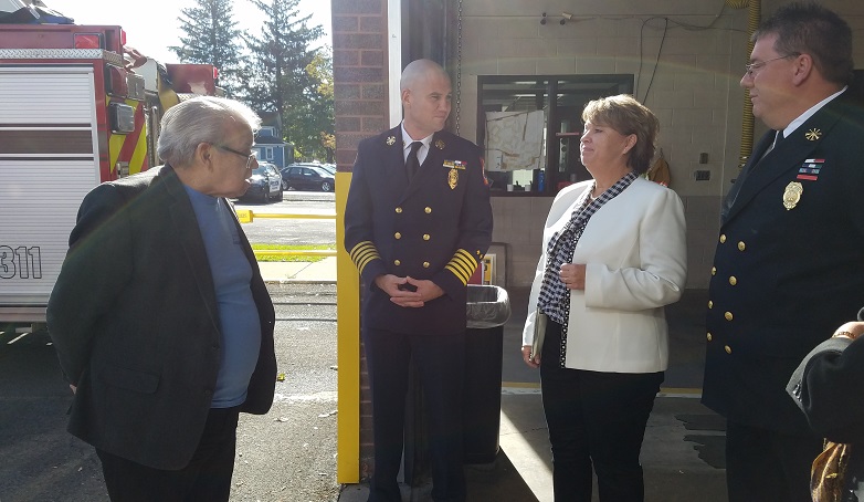 From left, Mayor Ronald Woodward Sr., Chief David Eiffe, Senator Patty Ritchie and Assistany Chief Shane Laws discuss the FFD's new ladder truck purchased through DASNY grant funding.