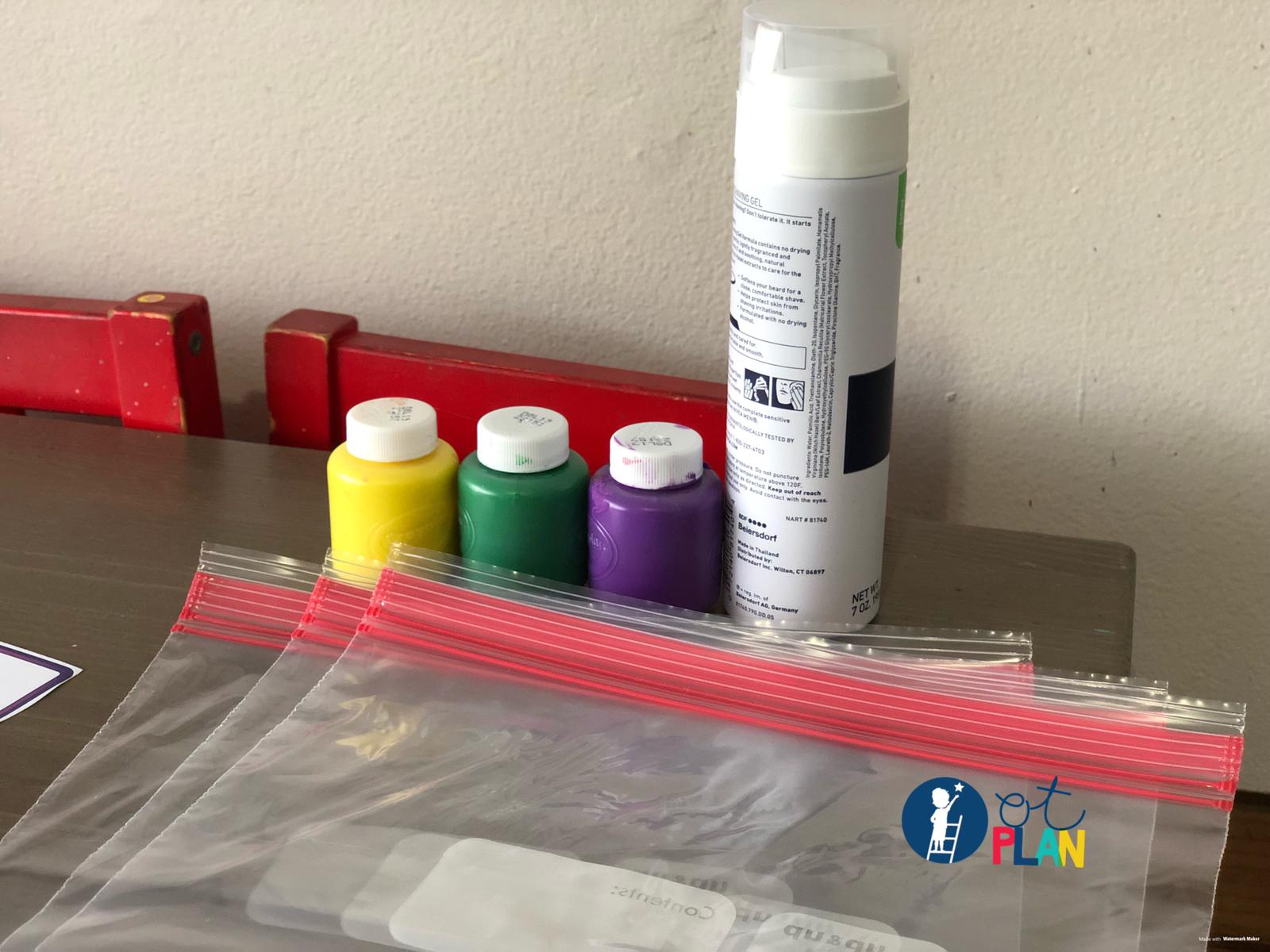 Materials for the tactile paint activity: paint, cut-out letters and supplies