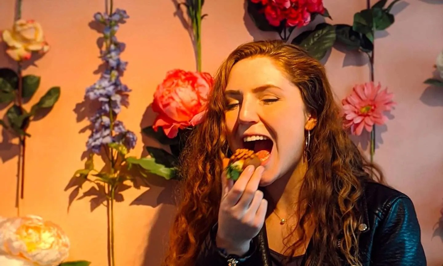 Traveler Liz eating a chocolate covered strawberry